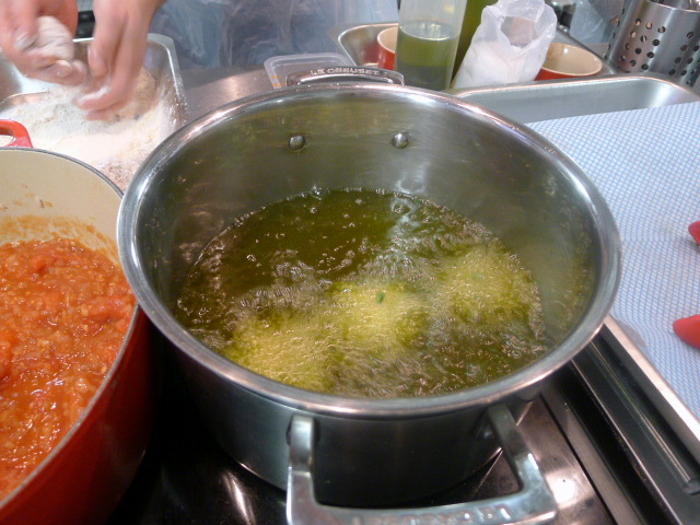 Deep frying meatballs in olive oil