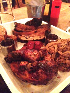 Porky's - The Ultimate includes a full portion of Memphis meaty ribs and tips, pulled pork, and half bbq chicken served with four hot links
